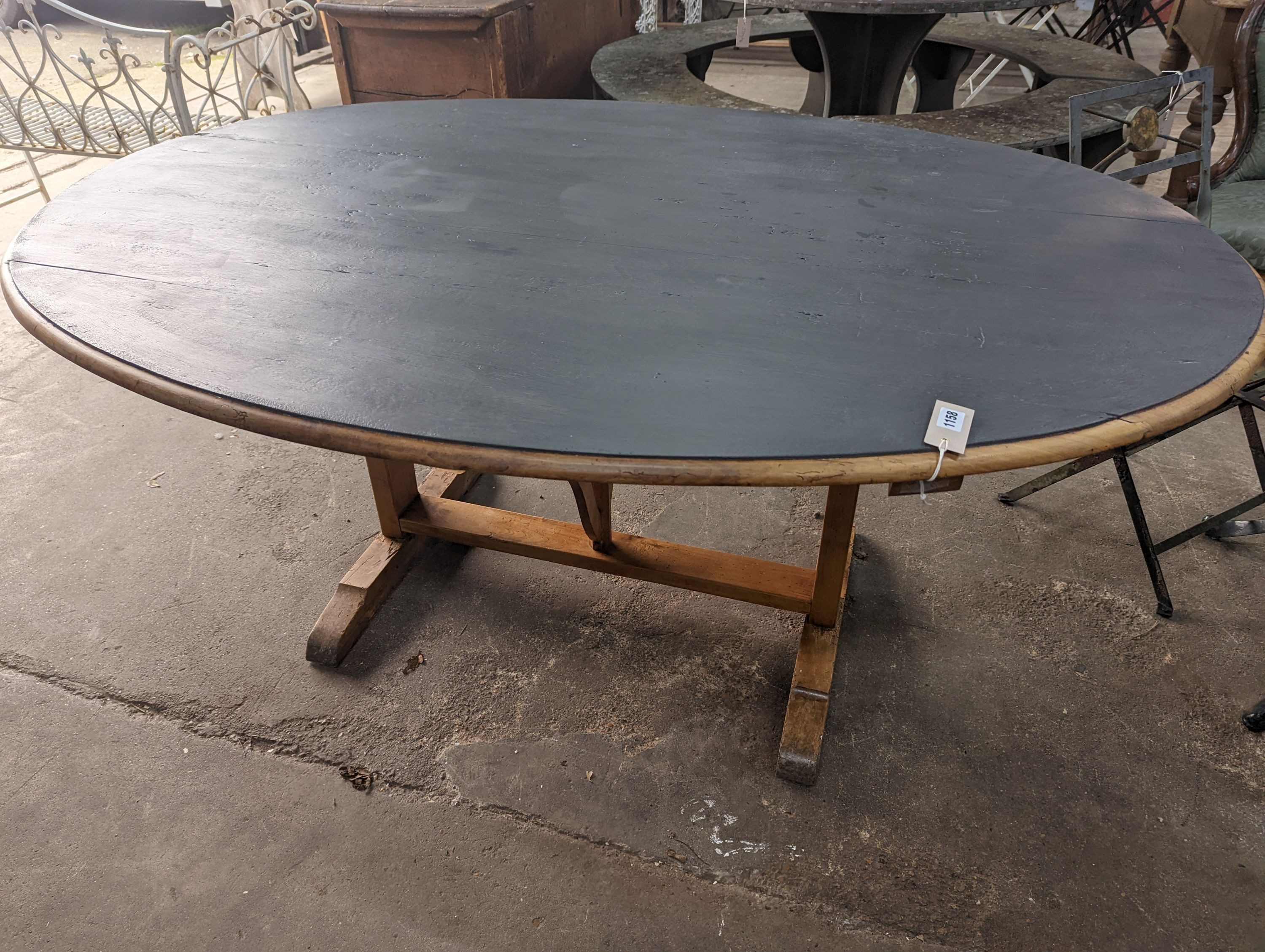 A French oval fruitwood Vendange wine tasting table with later painted top, length 174cm, depth 130cm, height 74cm